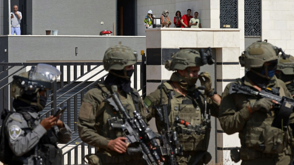 Palestinian residents trapped as Israeli settlers surround home in occupied West Bank village